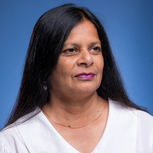 Woman with long black hair and white shirt