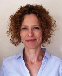 Woman with curly hair and blue shirt