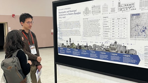 Woman and man stare at poster board