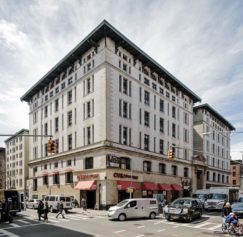 multi-story building at corner of busy intersection