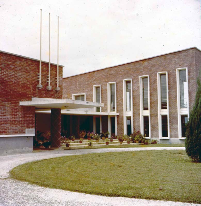 red brick building with tall white vertical glass windows