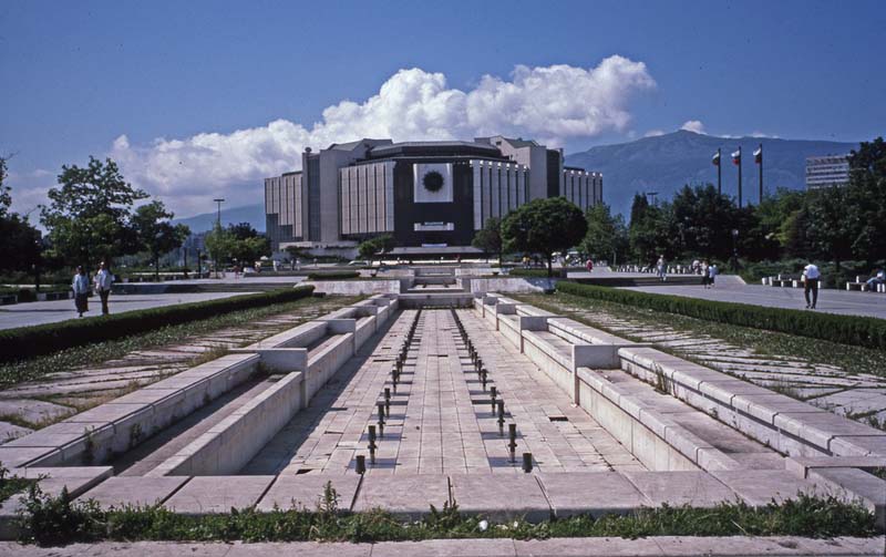 empty concrete fountain leading to massive building