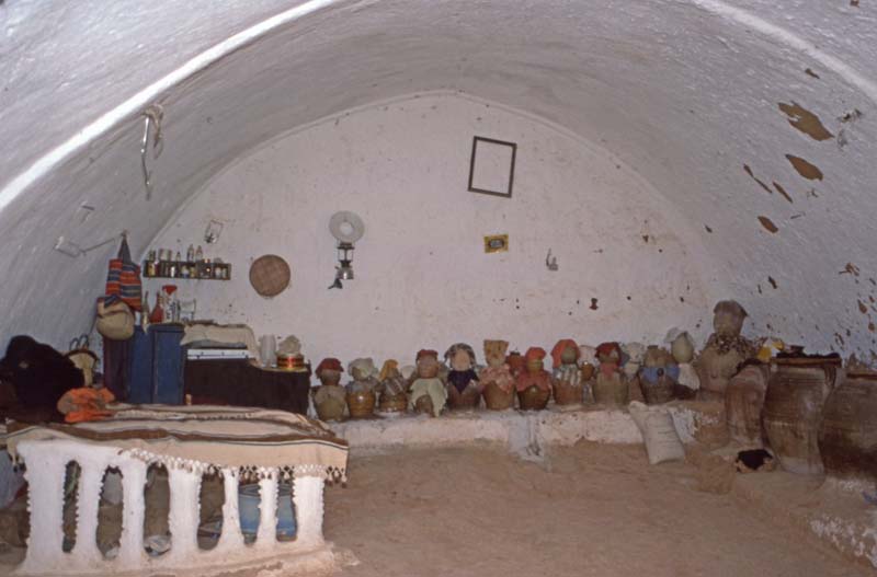 view of whitewashed vaulted room lined with clay pots