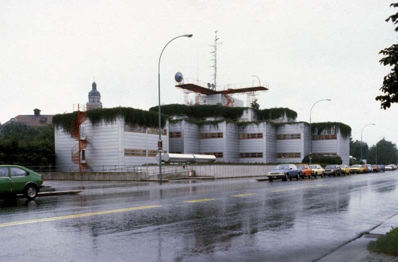 white building with green roof along street