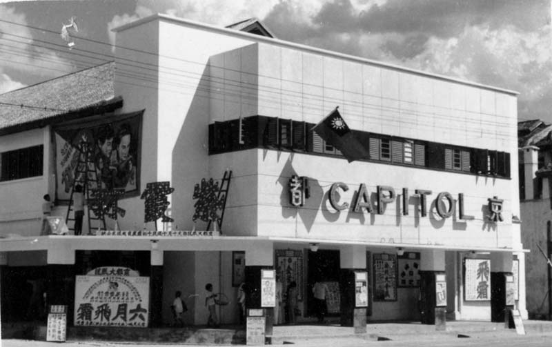 white building adorned with movie posters